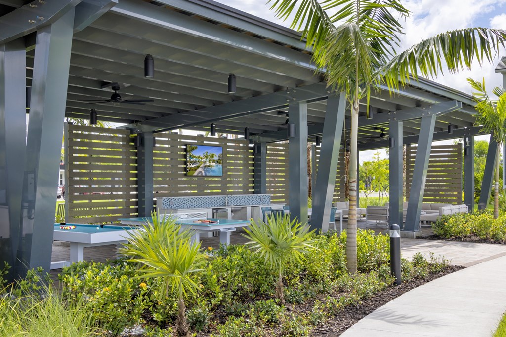 Covered Veranda with Outdoor Games at Everly Apartments in Naples, FL