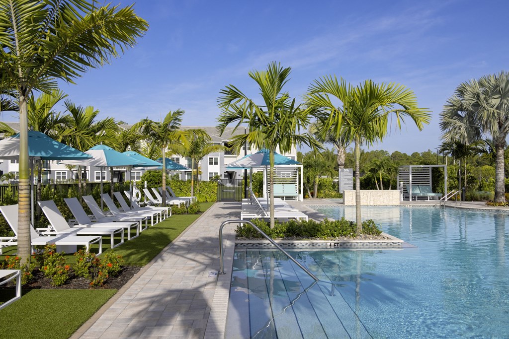 Heated Pool and Sun Loungers at Everly Apartments in Naples, FL