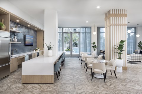 A modern kitchen with a dining table and chairs.