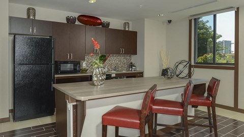 a kitchen with a counter and chairs