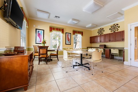 A kitchen with a table and chairs in the middle of the room.