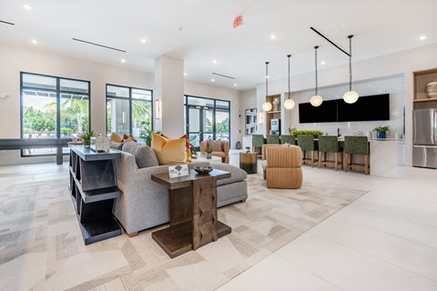 A modern living room with a large grey sofa and a wooden coffee table.