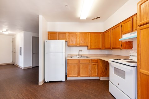 A kitchen with wooden cabinets and white appliances.