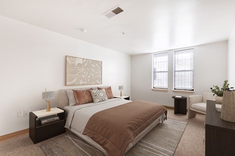 A bedroom with a large bed and a painting on the wall.