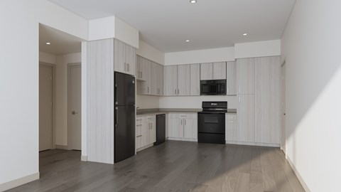 A modern kitchen with black appliances and white cabinets.