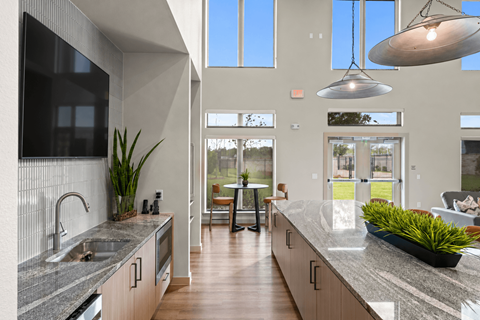 A modern kitchen with a long counter and a large island.