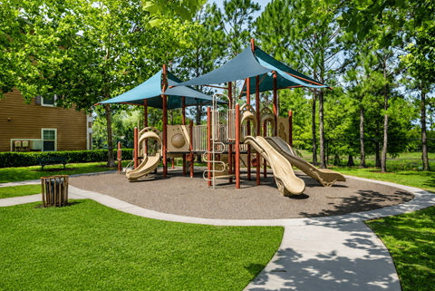 A playground with a blue canopy and a yellow slide.