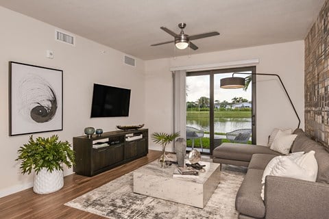 a living room with a couch and a tv and a sliding glass door