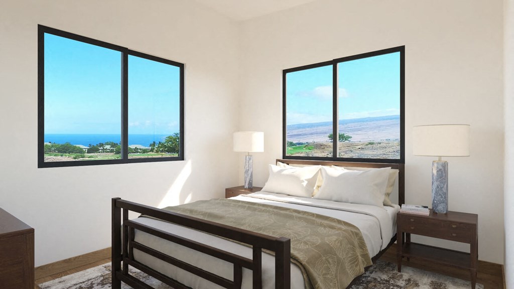 a bedroom with a bed and a view of the ocean