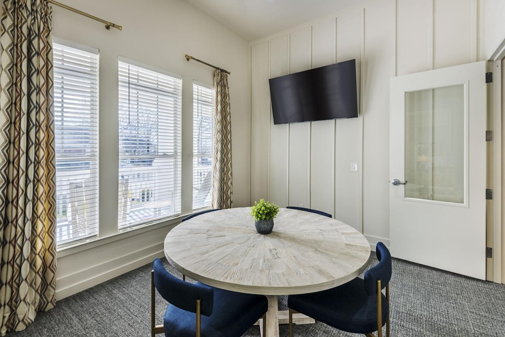 a dining room with a table and chairs and a television