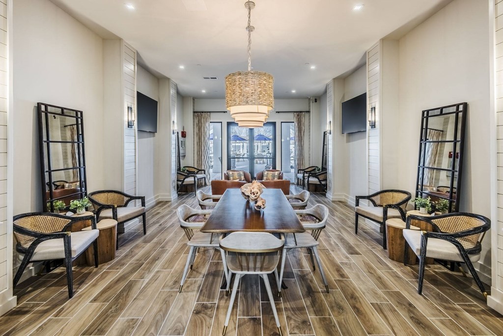 a dining room with a long table and chairs and a chandelier