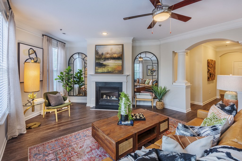 a living room with a ceiling fan and a fireplace