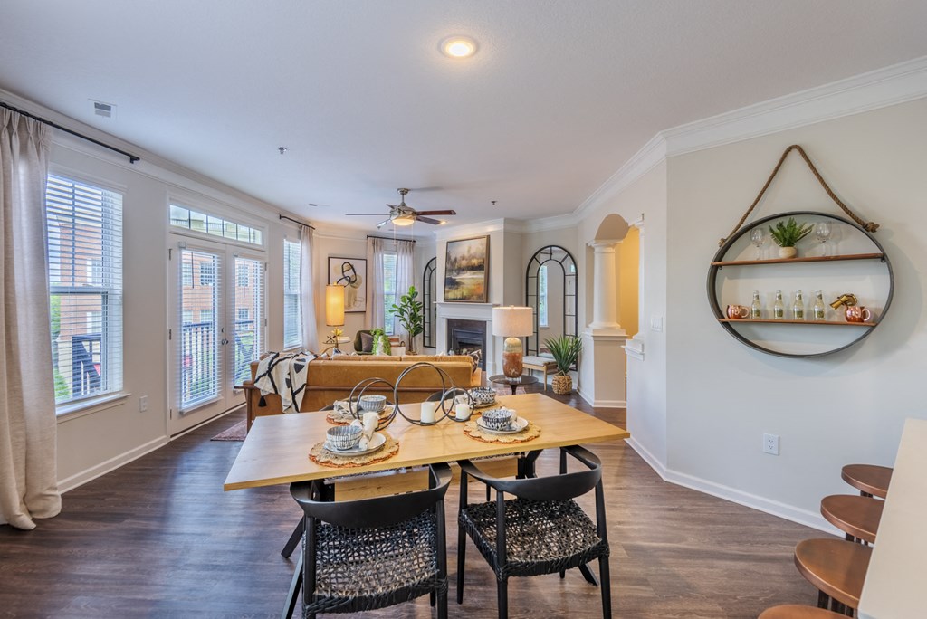the dining room and living room in a new home with a dining table and chairs