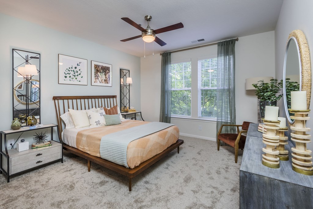 a bedroom with a large bed and a ceiling fan