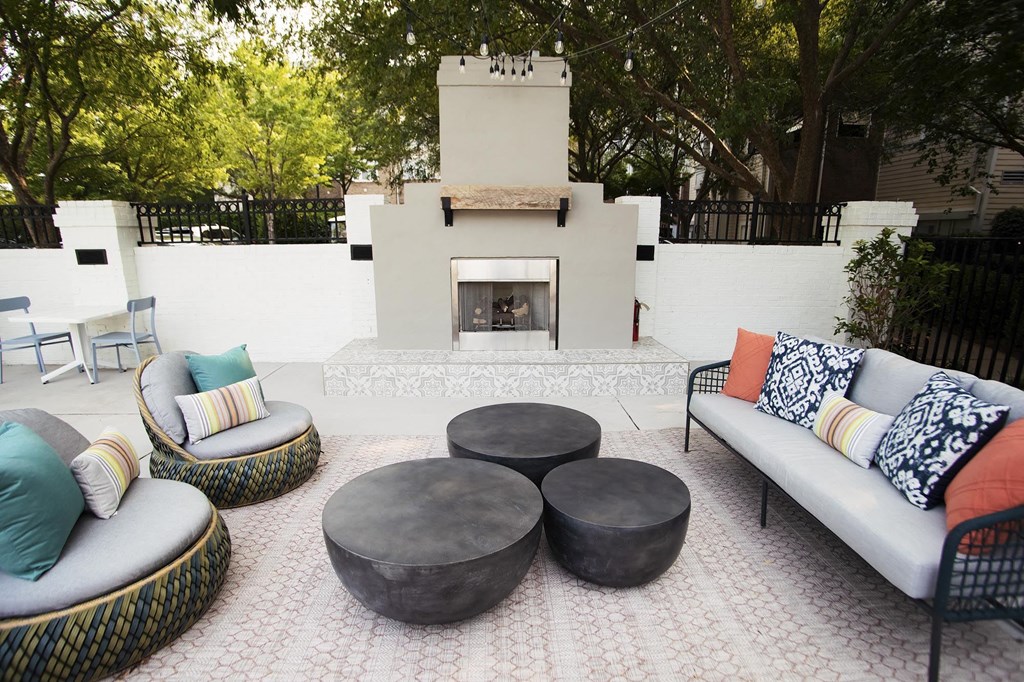 the outdoor patio has a fireplace and seating areas