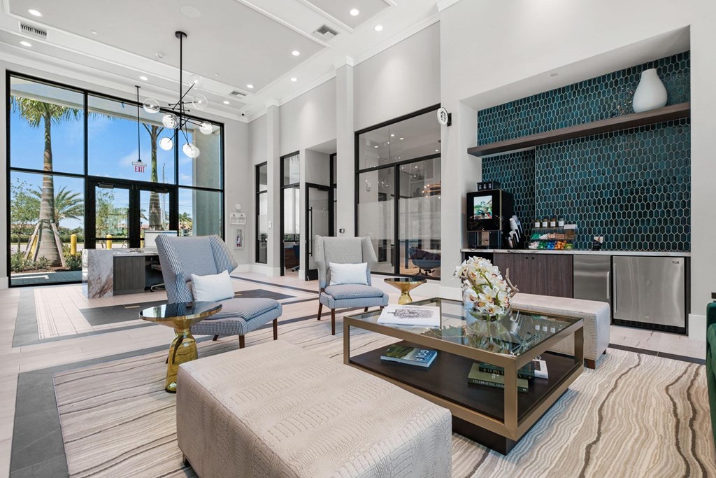 A modern living room with a glass coffee table and a large window.