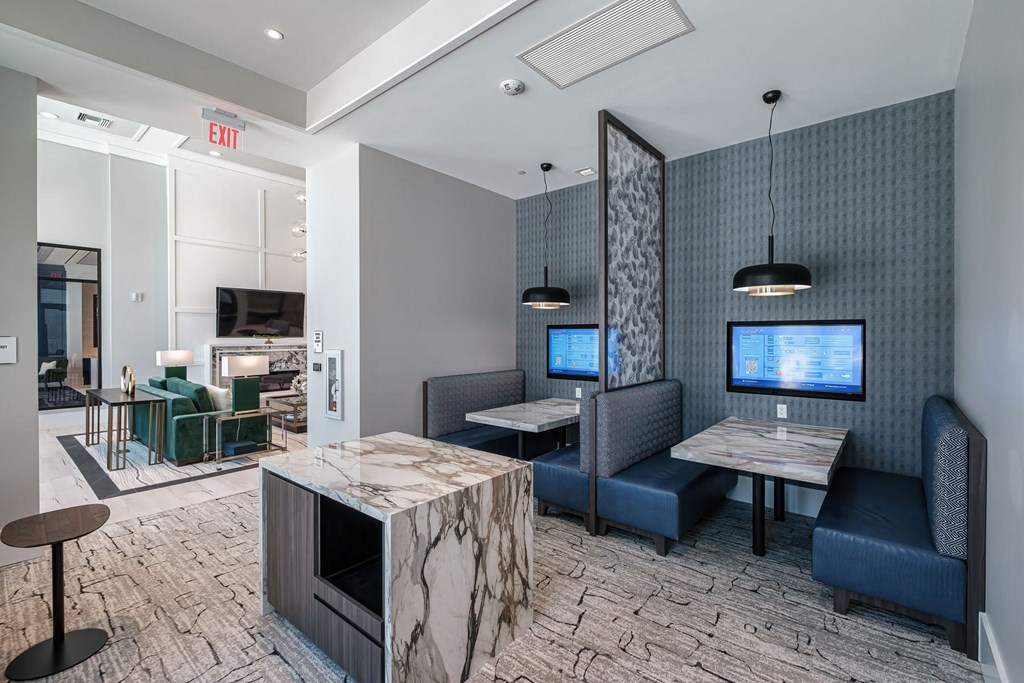 A modern lounge area with a bar and seating.