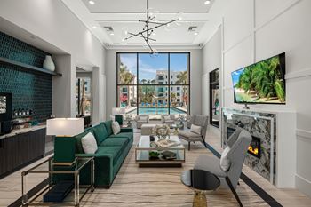 A modern living room with a green sofa and a fireplace.