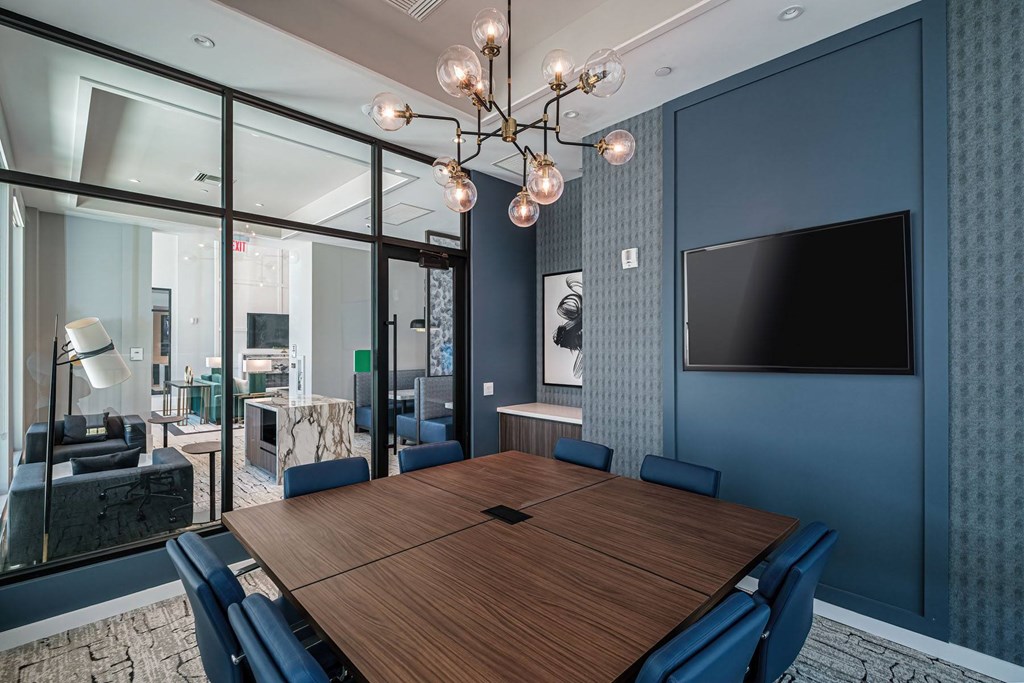 A conference room with a long table and chairs.