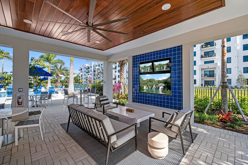 A patio with a table and chairs and a television.