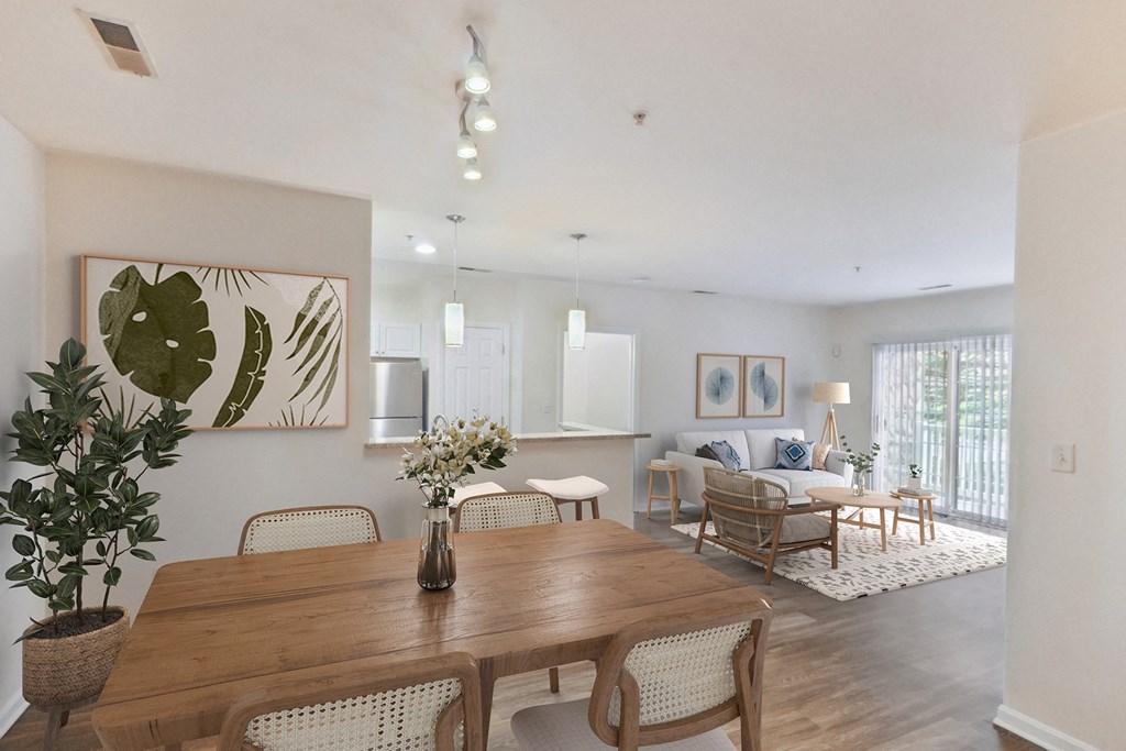 a living room and dining room with a wooden table and chairs at Highlands at Faxon Woods, Quincy, Massachusetts