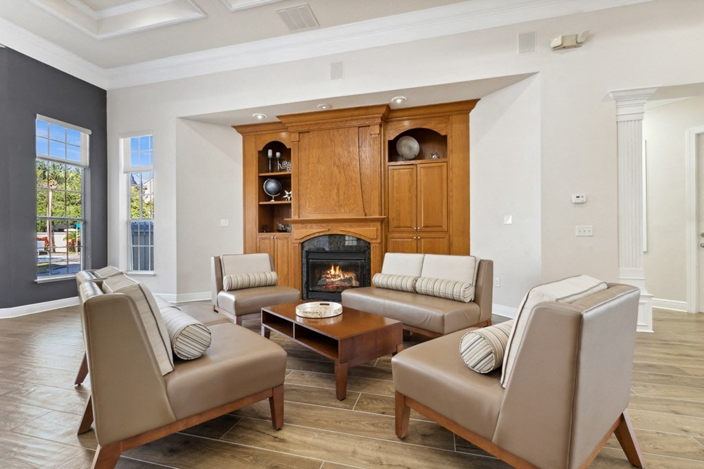 a living room with a fireplace and leather furniture at Grandeville on Saxon, Florida, 32763
