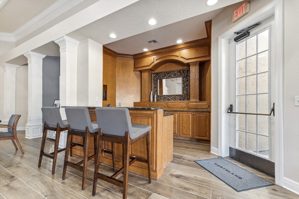 a kitchen with a bar and chairs in a house at Grandeville on Saxon, Orange City, Florida