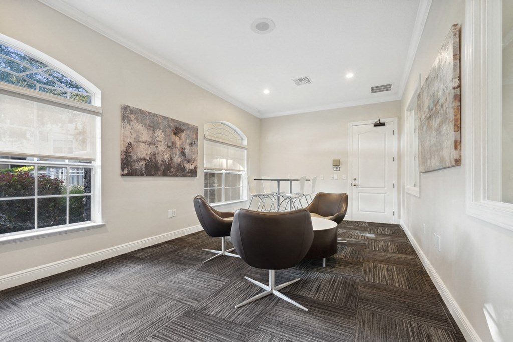 a conference room with a table and chairs at Grandeville on Saxon, Orange City, Florida