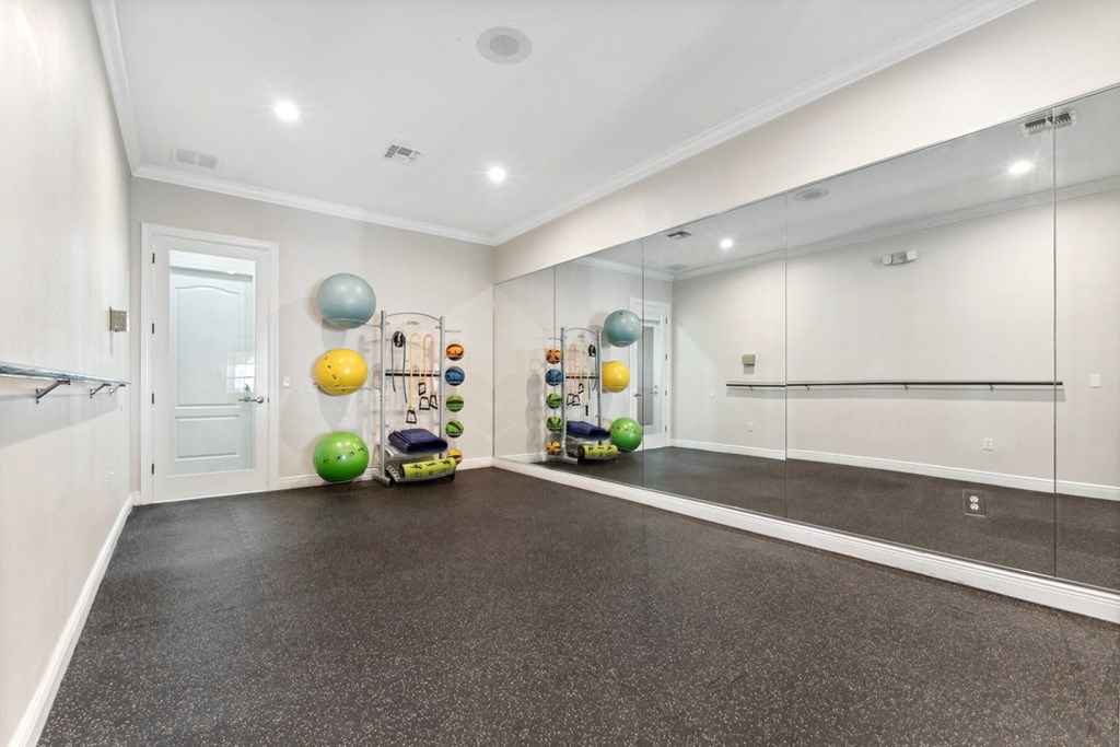 the living room has a workout room with weights and mirrors at Grandeville on Saxon, Florida