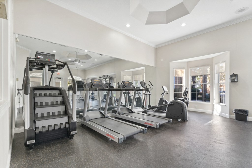 a gym with treadmills and other exercise equipment in a large room at Grandeville on Saxon, Florida