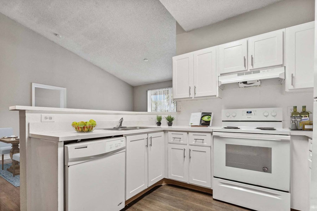 a white kitchen with white appliances and white cabinets at Cypress Shores, Coconut Creek, FL