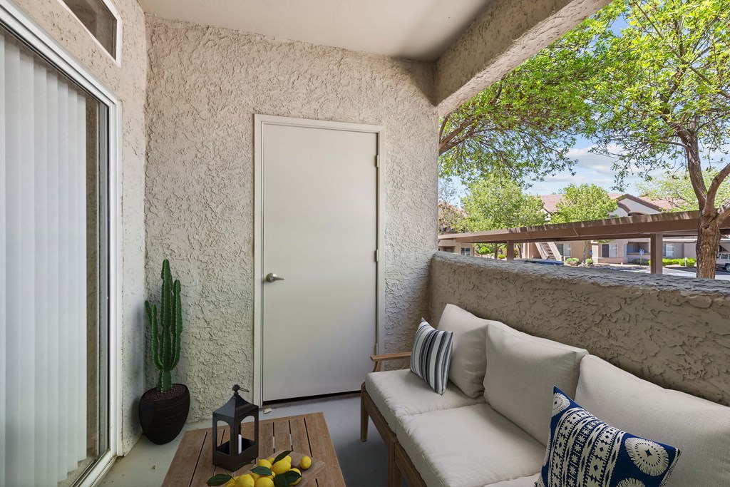 a small porch with a couch and a table