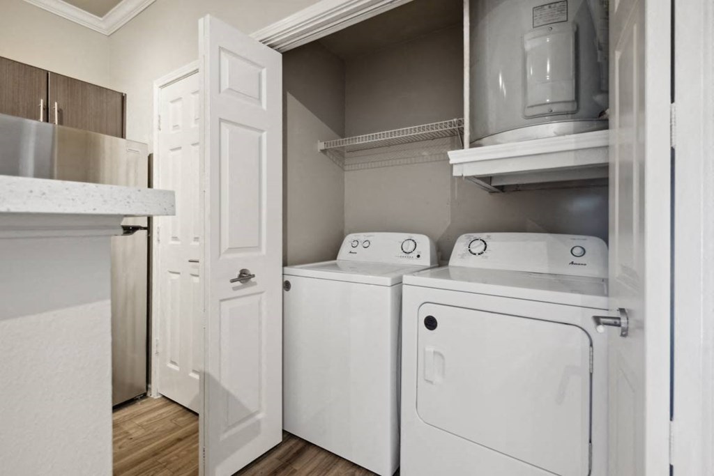 A white laundry room with a washer and dryer.