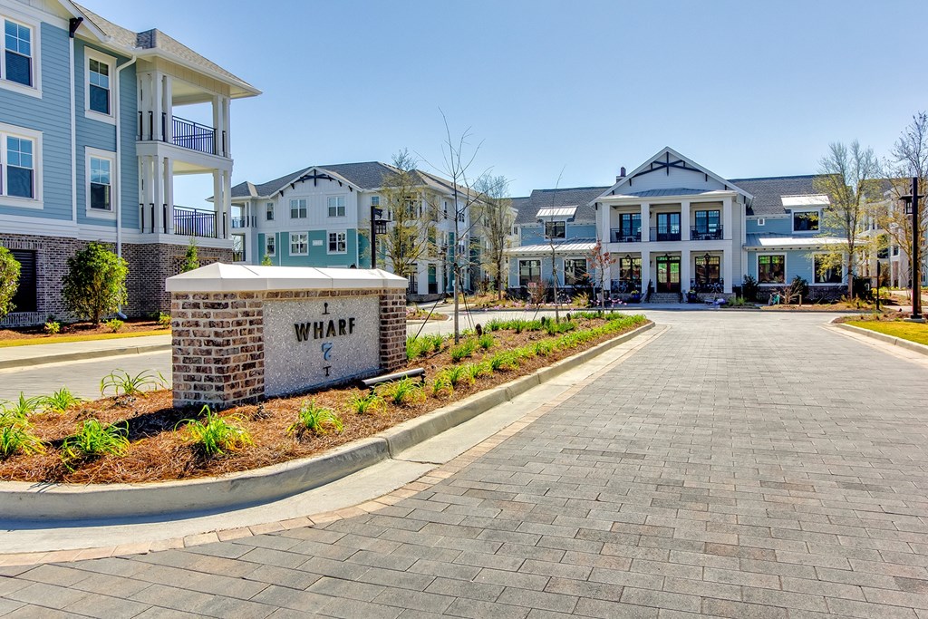 A brick sign that says at Wharf 7 Apartments, Charleston, SC 29492