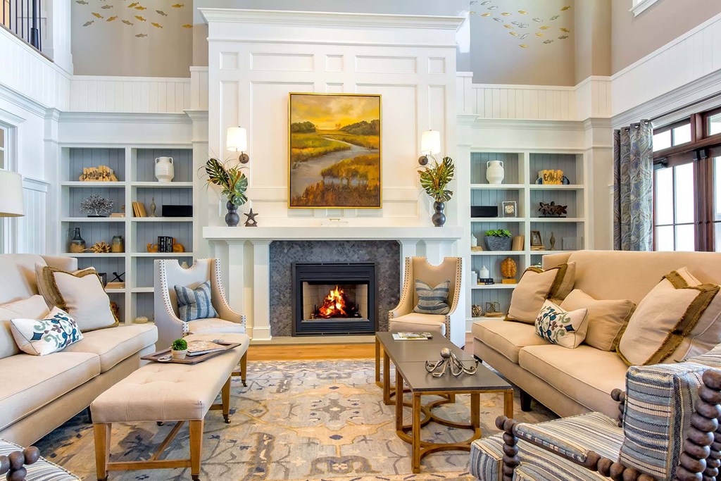 A living room with a fireplace and a painting above it at Wharf 7 Apartments, Charleston, SC