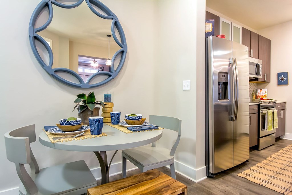 A kitchen with a round mirror and a table set for two at Wharf 7 Apartments, South Carolina 29492