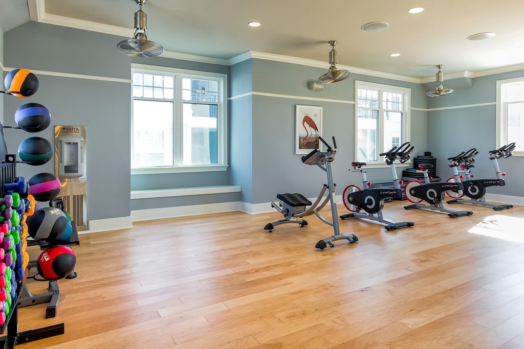A home gym with a variety of exercise equipment at Wharf 7 Apartments, Charleston, SC