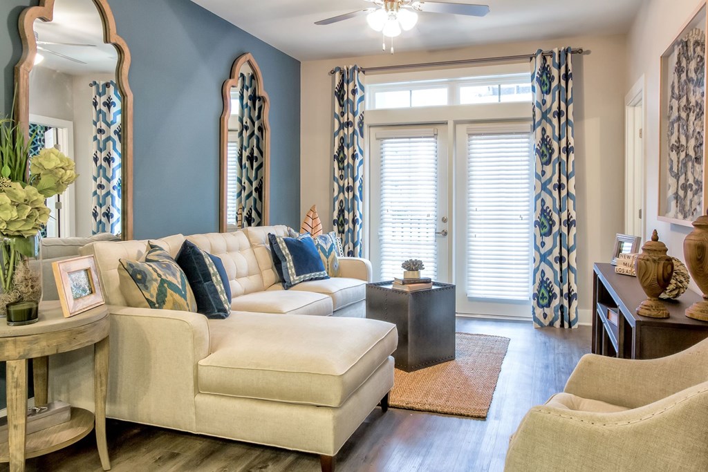 A living room with a white couch and a coffee table at Wharf 7 Apartments, Charleston, SC 29492