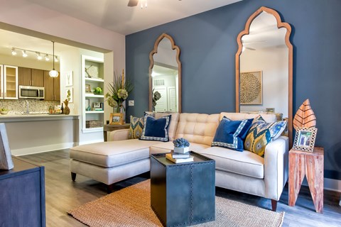 A living room with a white couch and a coffee table.