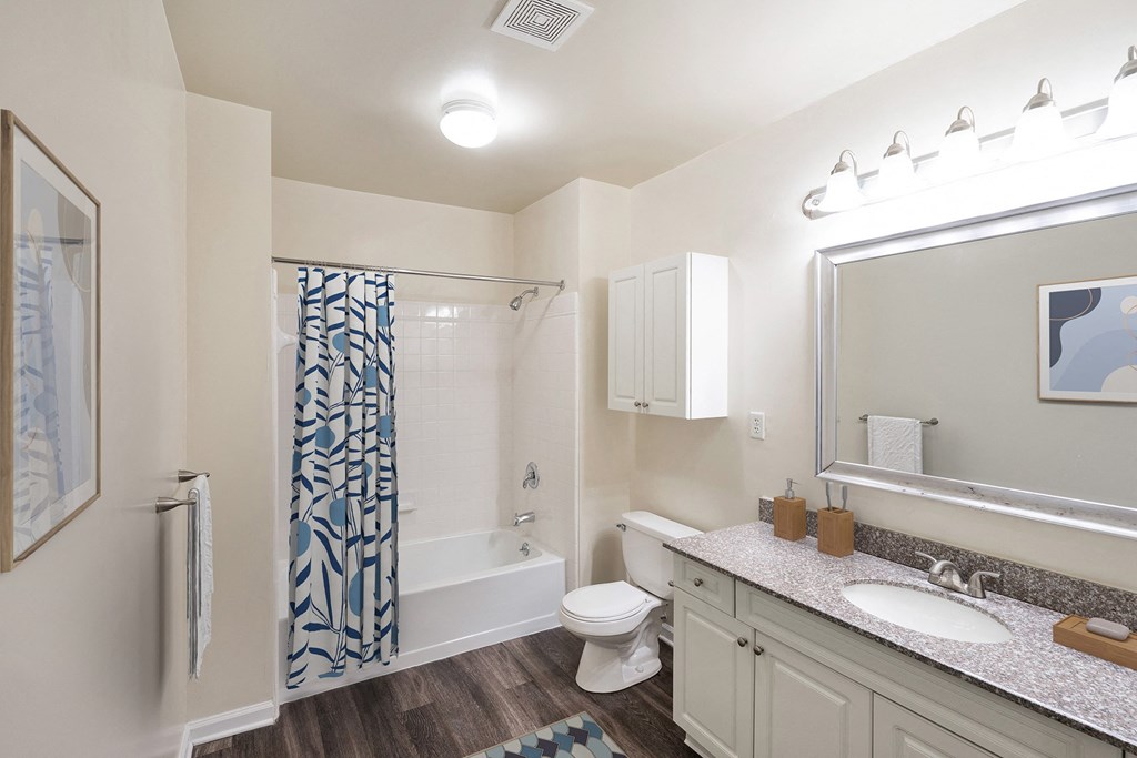 a bathroom with a shower toilet and sink and a mirror at Highlands at Faxon Woods, Quincy, MA, 02169
