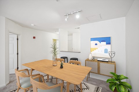 a dining room with a wooden table and chairs