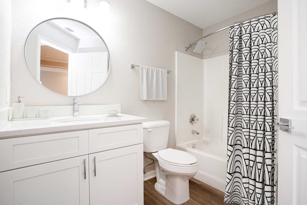 a bathroom with white cabinets and a black and white shower curtain  at Ashlar, Fort Myers, Florida