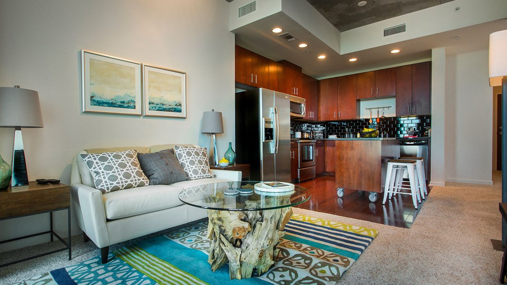 a living room with a white couch and a glass coffee table at Element, Tampa, FL