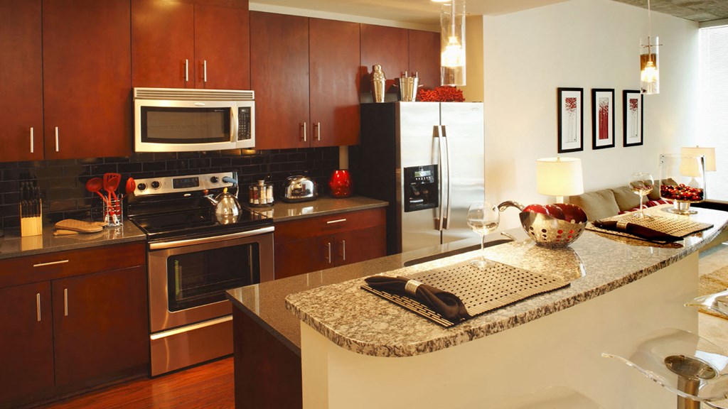 a kitchen with a large island with granite countertops at Element, Florida, 33602