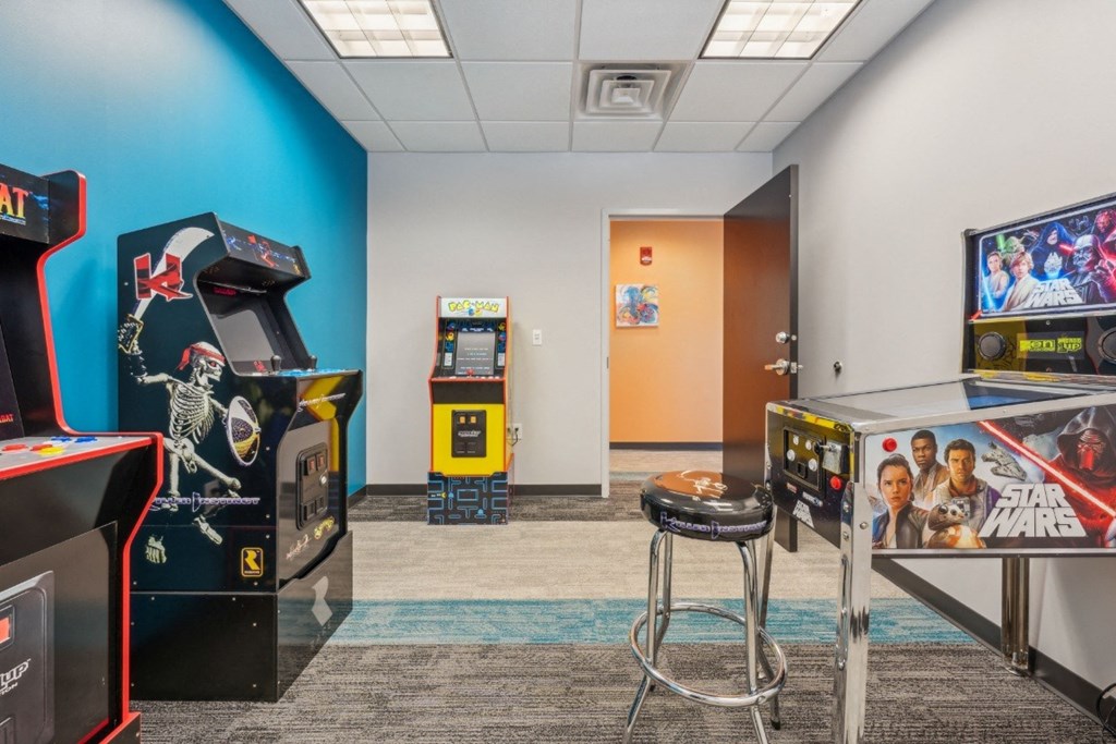 a game room with arcade games at the Residences at Manchester Place in Manchester, New Hampshire