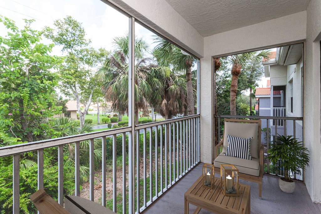 a balcony with a chair and a table at Ashlar, Fort Myers