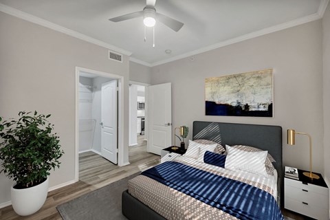 Bedroom with Wood-Style Plank Flooring a bedroom with a large bed and a ceiling fan at River Stone Ranch, Texas