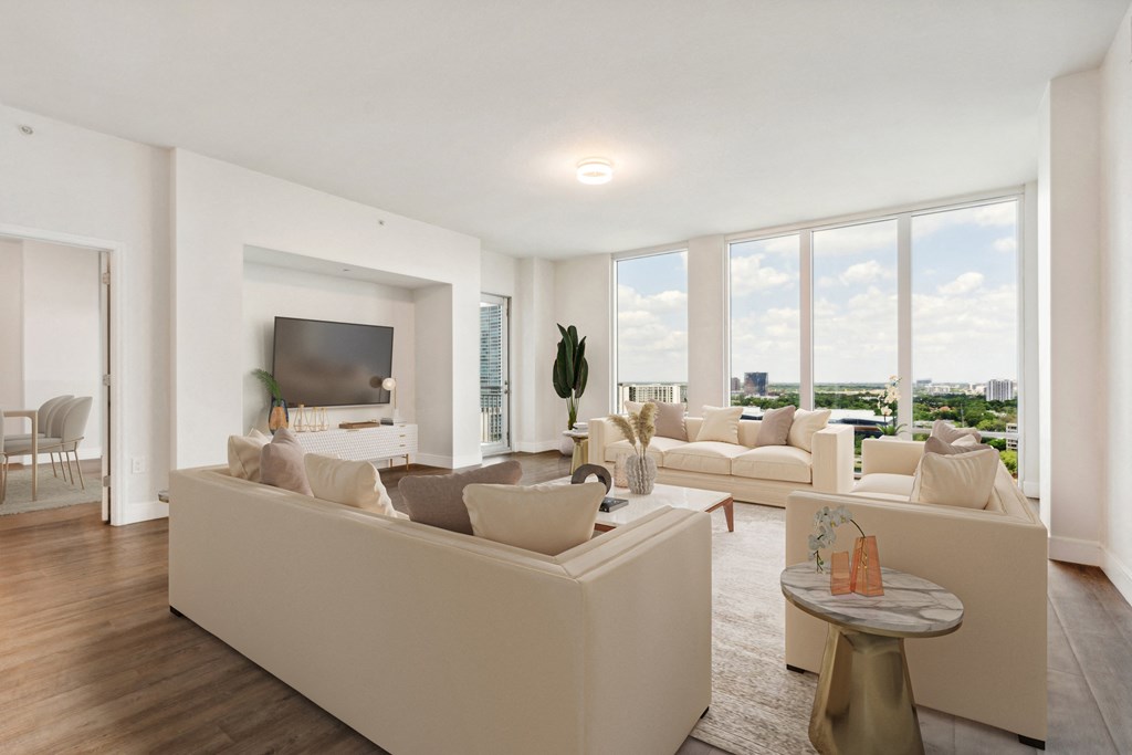 a living room with white couches and a large window at Paramount on Lake Eola, Orlando, Florida