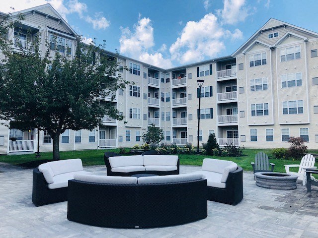 Outdoor patio with lounge seating at Highlands at Faxon Woods, Quincy