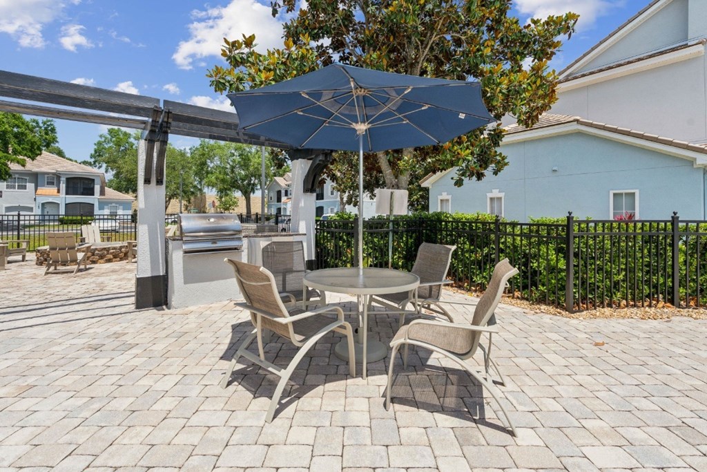 A BBQ and Grill area featuring a patio table and chairs